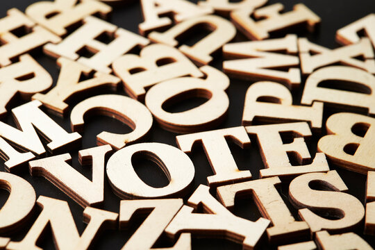 The word 'vote' between wooden letters