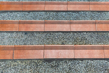 row of red tiles on gray stone base urban background