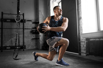sport, bodybuilding, fitness and people concept - young man exercising with medicine ball in gym - Powered by Adobe
