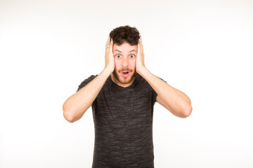 portrait isolated caucasian young man with surprised expression with hand on face