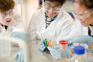 Fototapeta premium Students conducting scientific experiment in laboratory classroom