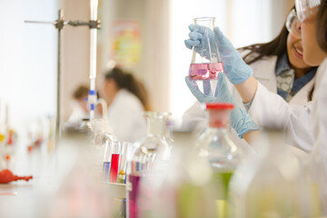 Students conducting scientific experiment in laboratory classroom