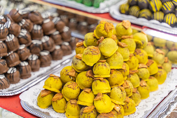 marzipan candies with yellow fondant stack sale at christmas market