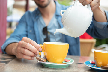a man pouring green tea