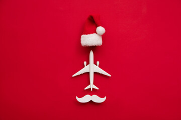Festive christmas travel reindeer made from airplane and antlers on a red background