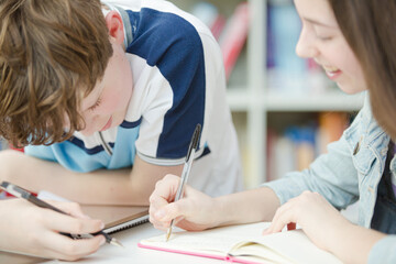 Students writing in notebook