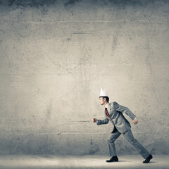 King businessman in elegant suit running in empty room