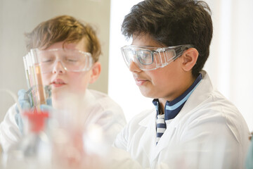 Students conducting scientific experiment in laboratory classroom