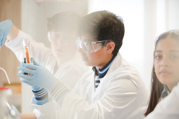 Students conducting scientific experiment in laboratory classroom