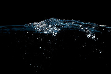Water Surface with Ripple and Bubbles Float Up on Black Background.
