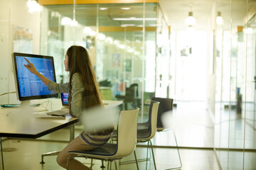 Girl student using computer at desk