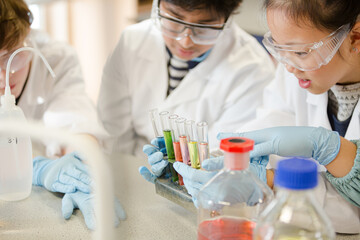 Students conducting scientific experiment in laboratory classroom