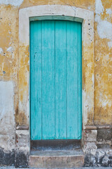 Light blue painted antique wooden door facade with copy space