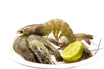 fresh gray shrimp and lime close up on white isolated background