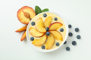 Concept of healthy food with peach yogurt on white background