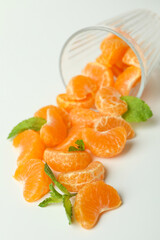 Concept of making mandarin juice with glass with mandarins on white background