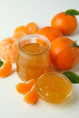 Mandarin jam and ingredients on white background