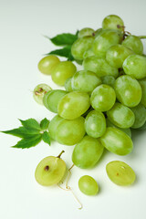 Green ripe grape with leaves on white background