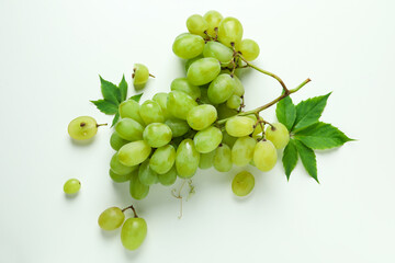 Green ripe grape with leaves on white background