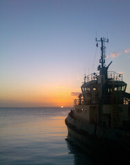 Fototapeta premium Fishing barge on the pier at sunset