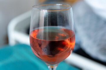 A glass of red wine. Teal ang orange