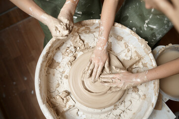 Children work on potter's wheel, top view