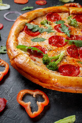 Fresh Homemade Italian Pizza Margherita with olives and red Bulgarian peppers on a dark background