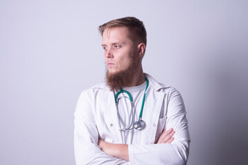Fototapeta premium Male doctor in laboratory coat on gray background