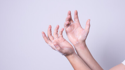 the man washes his hands with soap