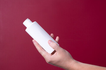 a man holding a bottle of lotion in his hand