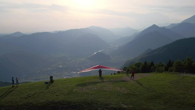 Scenic hang glider take off at the sunset high in the mountains