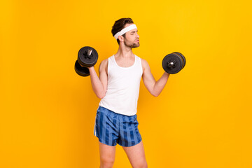 Portrait of attractive endurant strong sportive guy lifting weight work out isolated over bright...