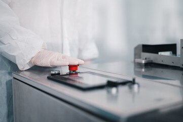 Scientists wearing protective clothing Inspect mask making machines in a laboratory at an industrial plant. Anti-virus production warehouse. concept of safety and prevention coronavirus covid-19.