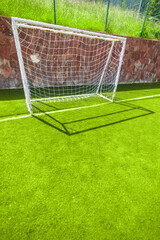 Football or soccer goal on an amateur small field with copy space, vertical