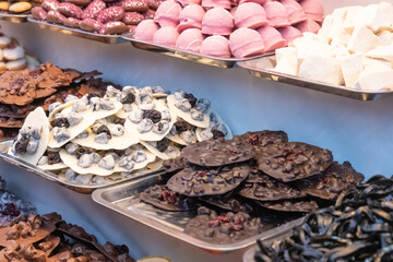 counter festive street fair sweets, pastry tray handmade chocolate and marzipan sweets selective focus