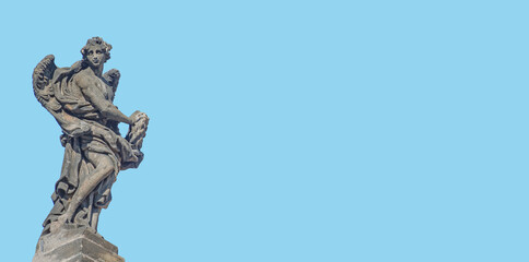 Banner with beautiful angel on Saint Francis of Assissi Church, Charles Bridge in Prague, with copy space, blue sky background, Czech Republic. Concept of travel, historical architecture conservation.