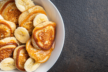 pancakes banana slices syrup or honey delicious breakfast sweet dessert fresh portion ready to eat meal snack on the table copy space food background rustic. top view keto or paleo diet