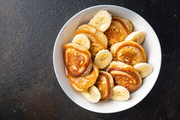 pancakes banana slices syrup or honey delicious breakfast sweet dessert fresh portion ready to eat meal snack on the table copy space food background rustic. top view keto or paleo diet