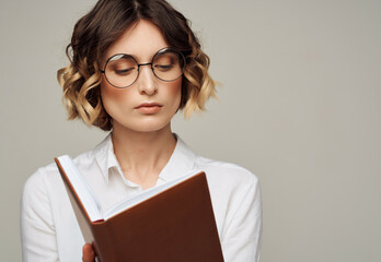 pretty woman in glasses with book elegant style for professionals Studio