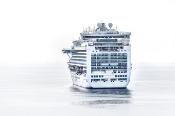 Luxury cruise liner anchored in the English Channel, UK. High key image of the rear of the ship on...