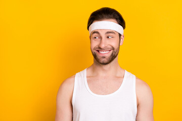 Portrait of attractive cheerful guy sportsman looking aside copy space isolated over bright yellow color background