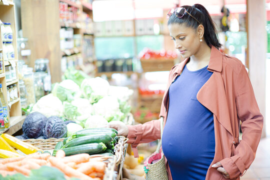 Pregnant woman shopping in grocery store