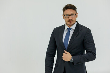 Isolated portrait studio shot of Caucasian masculine handsome smart confident professional successful businessman in formal black suit optical eyeglasses standing look at camera on white background