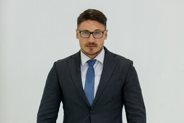 Isolated portrait studio shot of Caucasian masculine handsome smart confident professional successful businessman in formal black suit optical eyeglasses standing look at camera on white background
