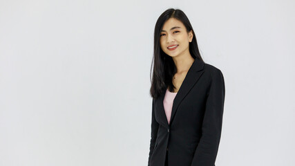 Isolated portrait studio shot of Asian young pretty smart confident happy professional success female businesswoman officer in black formal suit standing smiling look at camera on white background
