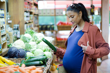 Pregnant woman shopping in grocery store