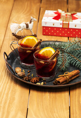 Christmas festive mulled wine with spices in glass cups a Christmas decorations and gifts. Festive card