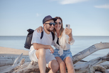 Young couple make selfie at the sea.