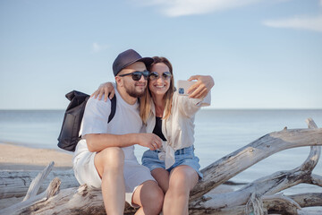 Young couple make selfie at the sea.