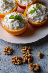 Celery salad with apple and walnuts served in orange cups.